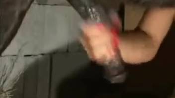 Blonde strokes her cunt while giving a delightful bestiality blowjob