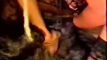 A dark-haired man vigorously fucks a sexy slut in stockings from behind